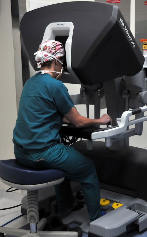 Maj. Lauren Buck, 81st Surgical Operations Squadron general surgeon, operates using the da Vinci Xi during a ventral hernia repair surgery March 28, 2017, on Keesler Air Force Base, Miss. The da Vinci Xi robot system, which cost approximately $2 million, translates the surgeon’s hand motions into smaller more precise movements. The robot’s tiny instruments create more internal space inside the patient’s body during the operation. (U.S. Air Force photo by Senior Airman Jenay Randolph)	