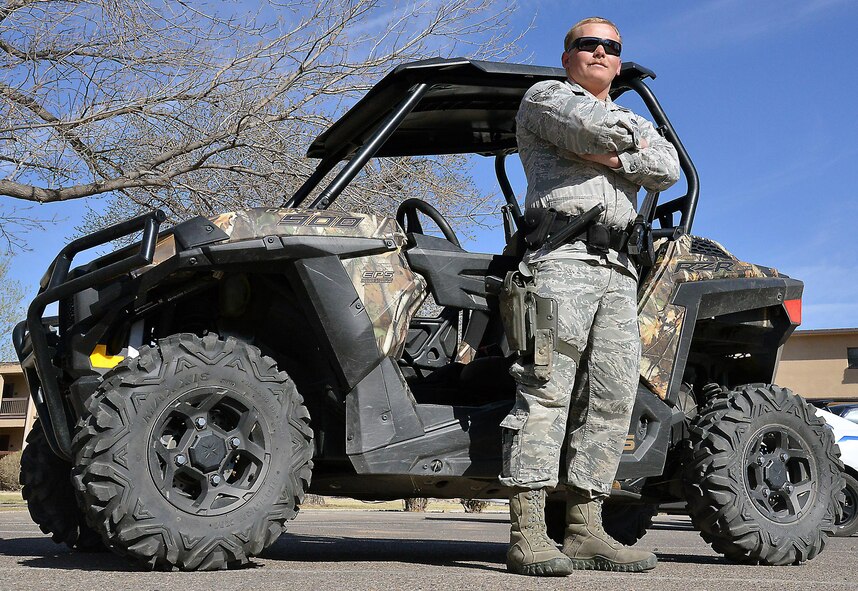 Senior Airman Jason Newsom, 377th Security Forces Squadron installation patrolman, stands with his Polaris RZR 900 EPS Razor at Kirtland March 21. SFS Airmen patrol the Kirtland fence line in remote areas using Razor all-terrain vehicles. (U.S. Air Force Photo/Senior Airman Chandler Baker) 