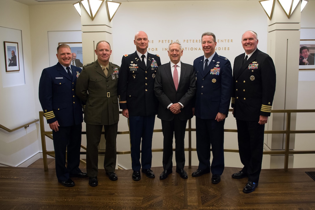 Defense Secretary Jim Mattis stands for a photo with commissioned officers.