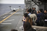 College students from Okinawa, Japan watch a Marine MV-22B Osprey land aboard the USS Bonhomme Richard (LHD 6) in the Pacific Ocean, March 25, 2017. College students from Okinawa International University, Ryukyu University and Toyo Medical Community College toured the USS Bonhomme Richard (LHD 6) as part of a military exchange experience during the 31st Marine Expeditionary Unit’s 17.1 Spring Patrol of the Indo-Asia-Pacific region. Education programs, such as this military exchange experience, increase cooperation, trust and understanding between the U.S. military and the Okinawan community. As the Marine Corps’ only continuously forward deployed unit, the 31st Marine Expeditionary Unit’s air-ground-logistics team provides a flexible force, ready to perform a wide range of military operations, from limited combat to humanitarian assistance operations, throughout the Asia-Pacific region. 