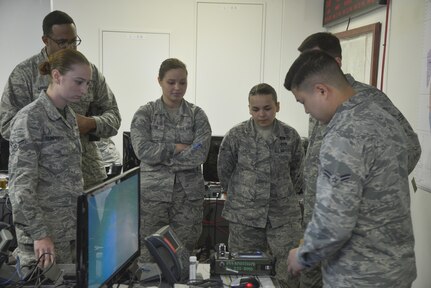 Airman 1st Class Dong Han, 374th Aerospace Medical Squadron bioenvironmental engineering technician, discusses how to properly use a HazMatID elite device to detect unknown chemical and biological agents at Yokota Air Base, Japan, March 24, 2017. The bioenvironmental section also provided briefings on their mission in the emergency operation center and chemical attack references. 