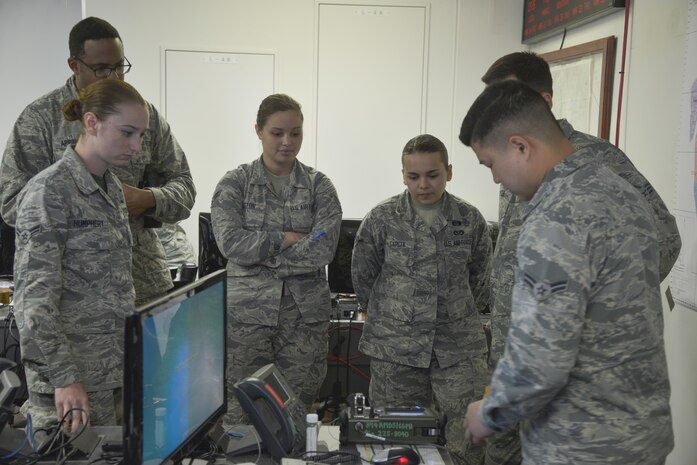 Airman 1st Class Dong Han, 374th Aerospace Medical Squadron bioenvironmental engineering technician, discusses how to properly use a HazMatID elite device to detect unknown chemical and biological agents at Yokota Air Base, Japan, March 24, 2017. The bioenvironmental section also provided briefings on their mission in the emergency operation center and chemical attack references. 