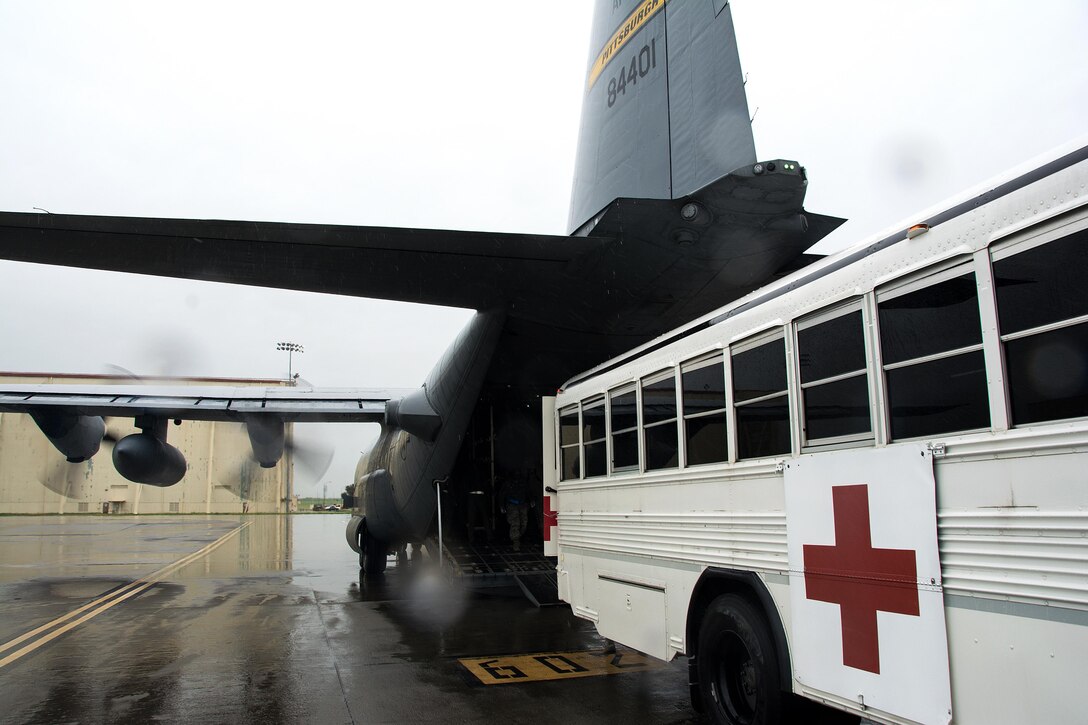An ambulance bus from the 60th Inpatient Squadron backs up to a C-130 Hercules from Pittsburgh Air Reserve Station, Penn., during Patriot Delta at Travis Air Force Base, Calif. on March 24, 2017. Members of the 60th IPTS participated in the Air Force Reserve exercise Patriot Delta, providing enroute patient care and staging the medical manikins. (U.S. Air Force photo by Staff Sgt. Daniel Phelps)