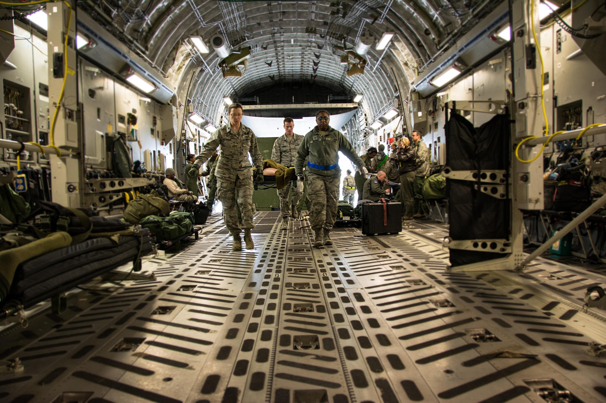 Patriot Delta participants carry a litter with a medical manikin patient onto a C-17 Globemaster III during Patriot Delta at Travis Air Force Base, Calif. on March 24, 2017. Patriot Delta brought in aeromedical evacuations squadrons from the from the 911th Airlift Wing at Pittsburgh Air Reserve Station, Penn., the 908th AW at Maxwell Air Force Base, Miss.; the 932d Airlift Wing at Scott AFB, Ill.; and the 349th Air Mobility Wing at Travis AFB. (U.S. Air Force photo by Staff Sgt. Daniel Phelps)