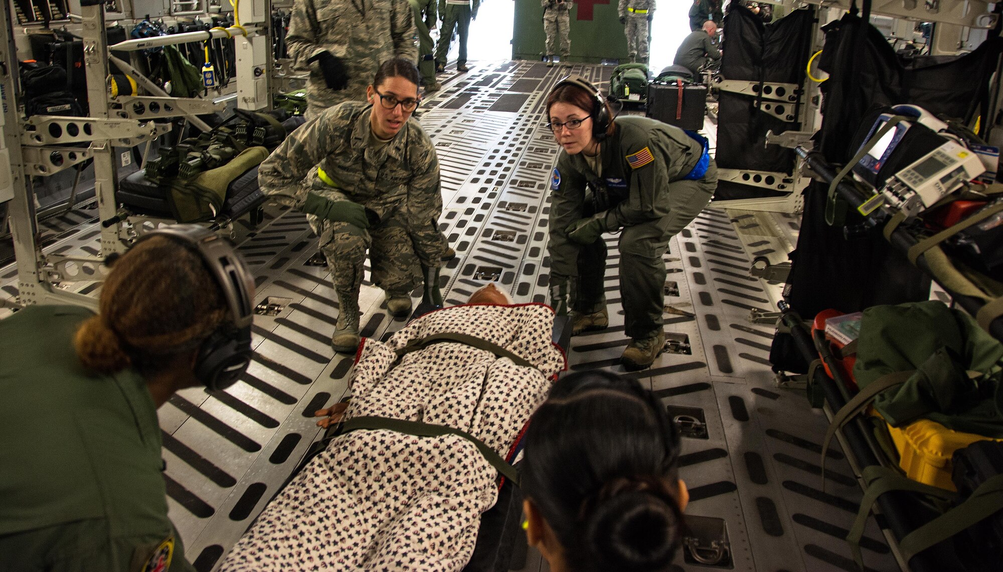 Patriot Delta participants carry a litter with a medical manikin patient onto a C-17 Globemaster III during Patriot Delta at Travis Air Force Base, Calif. on March 24, 2017. Patriot Delta brought in aeromedical evacuations squadrons from the from the 911th Airlift Wing at Pittsburgh Air Reserve Station, Penn., the 908th AW at Maxwell Air Force Base, Miss.; the 932d Airlift Wing at Scott AFB, Ill.; and the 349th Air Mobility Wing at Travis AFB. (U.S. Air Force photo by Staff Sgt. Daniel Phelps)