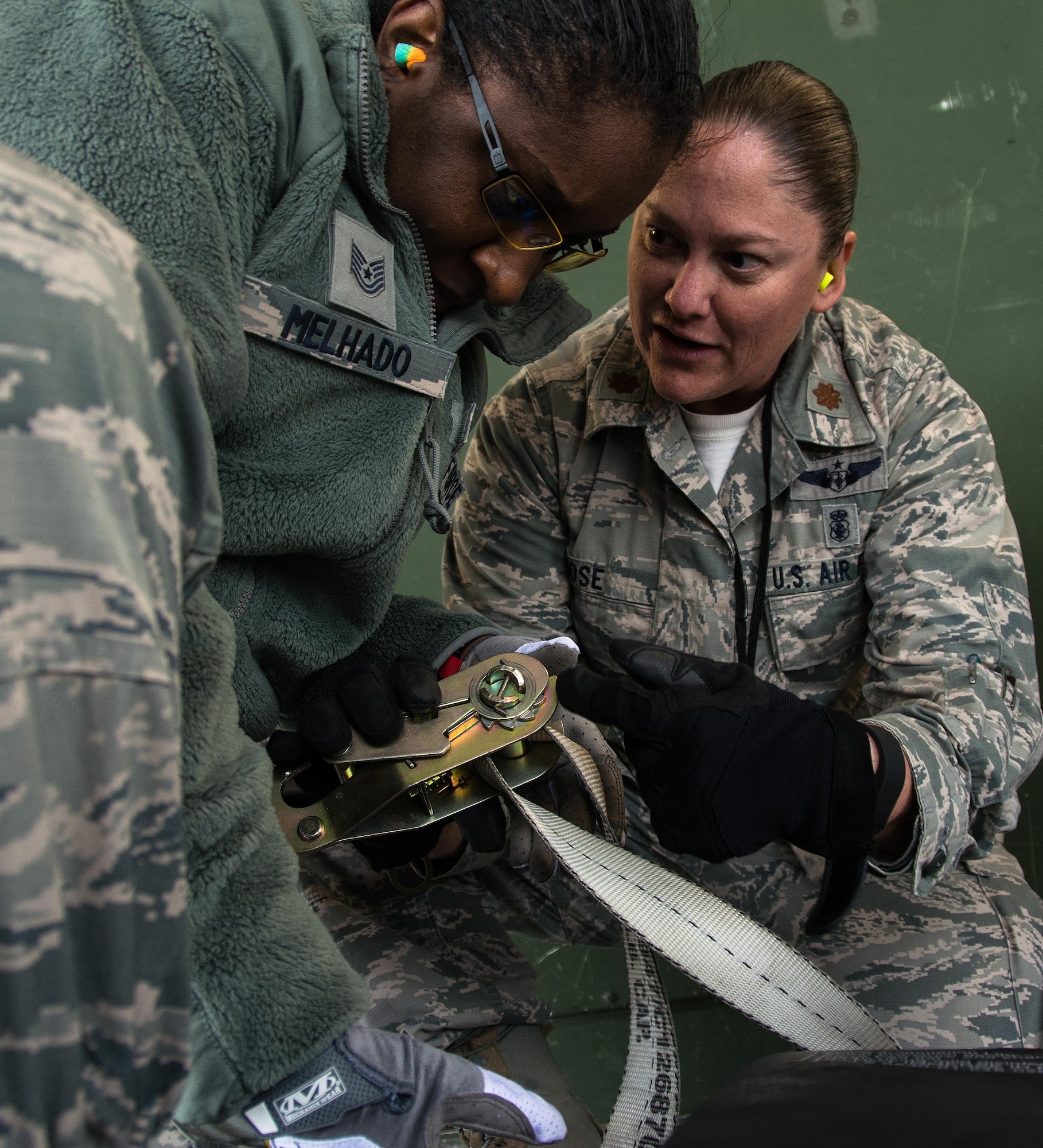 Maj. Kelly Rose, 349th Aeromedical Evacuation Squadron operations flight commander, instructs Tech. Sgt. Anna Melhado, 60th Inpatient Squadron medical technician, on how to properly secure a litter onto an aircraft during Patriot Delta at Travis Air Force Base, Calif. on March 24, 2017.  Members of the 60th IPTS participated in the Air Force Reserve exercise Patriot Delta, providing enroute patient care and staging the medical manikins. (U.S. Air Force photo by Staff Sgt. Daniel Phelps)