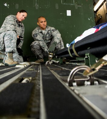 Maj. Kelly Rose, 349th Aeromedical Evacuation Squadron operations flight commander, instructs Tech. Sgt. Richard Manutag, 312th Airlift Squadron operations technician, on how to properly secure a litter onto an aircraft during Patriot Delta at Travis Air Force Base, Calif. on March 24, 2017.  Patriot Delta brought in aeromedical evacuations squadrons from the from the 911th Airlift Wing at Pittsburgh Air Reserve Station, Penn., the 908th AW at Maxwell Air Force Base, Miss.; the 932d Airlift Wing at Scott AFB, Ill.; and the 349th Air Mobility Wing at Travis AFB. (U.S. Air Force photo by Staff Sgt. Daniel Phelps)
