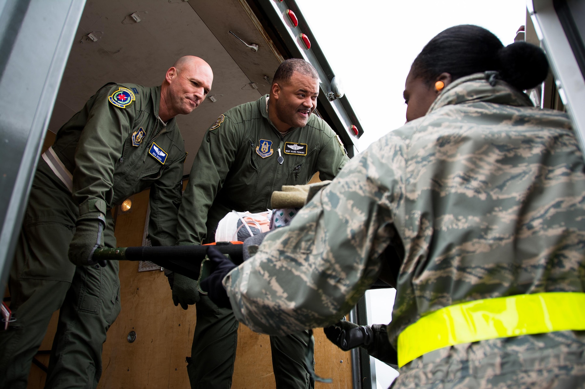 Capt. Erik Spiess, 349th Aeromedical Evacuations Squadron flight nurse, and Master Sgt. Rard Perkins, 911th Operations Group aircrew trainer, hand off a patient to members of the 60th Inpatient Squadron to secure on an ambulance bus for delivery to David Grant U.S. Air Force Medical Center at Travis Air Force Base, Calif., on March 24, 2017. Members of the 60th IPTS participated in the Air Force Reserve exercise Patriot Delta, providing enroute patient care and staging the medical manikins. (U.S. Air Force photo by Staff Sgt. Daniel Phelps)