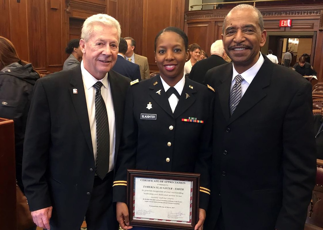 In honor of Women's History Month Capt. Nikki Slaughter-Smith, 328th Combat and Operational Stress Control, Army Reserve, was recognized along with several other prominent women during a special ceremony at the Buffalo N.Y. Veterans Court March 28, 2017.  She was recognized for her outstanding leadership and dedicated service to our country and our courts as a part-time Soldier, full-time Citizen Airman social worker with the 914th Airlift Wing, Air Force Reserve, and volunteer Veterans Court Mentor.  Pictured with Capt. Slaughter-Smith is Robert T. Russell, Veterans Treatment Court Judge (right), and Jack O'Connor, Veterans Court Mentor Coordinator.  (Courtesy photo)