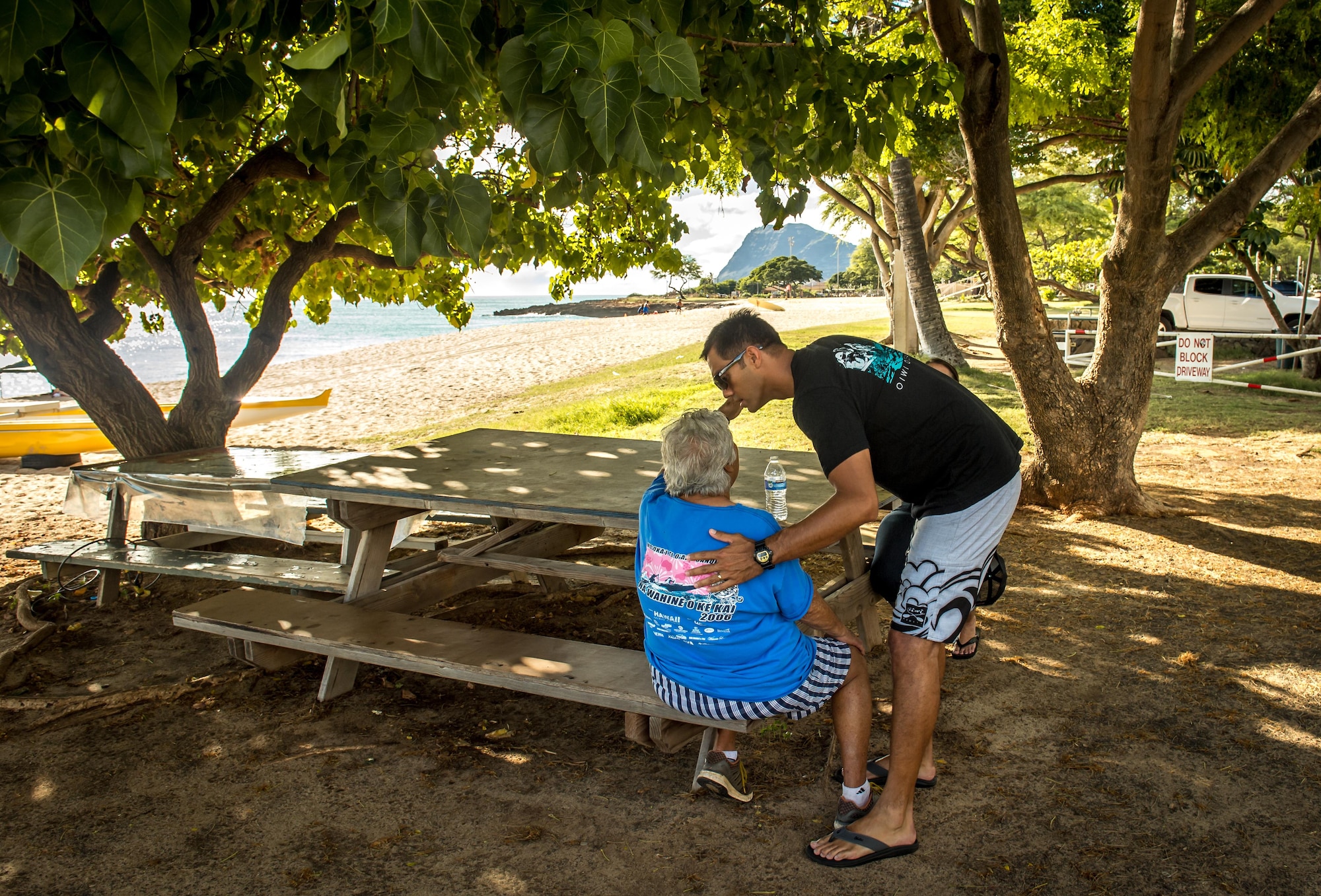 Then Tech. Sgt. Alfred Van Gieson, now Master Sgt., of 48th Aerial Port Squadron, 624th Regional Support Group, Joint Base Pearl Harbor-Hickam, kisses his grandmother, Edith Van Gieson, after arriving from duty to coach outrigger paddling at the Leeward Kai Canoe Club at Kalaianaole Beach Park in Nanakuli, Oahu, Hawaii, Aug 11, 2016. Edith, know as &quot;Aunty Edie&quot; to club members, founded the paddling club with her husband. (U.S. Air Force photo by J.M. Eddins Jr.)