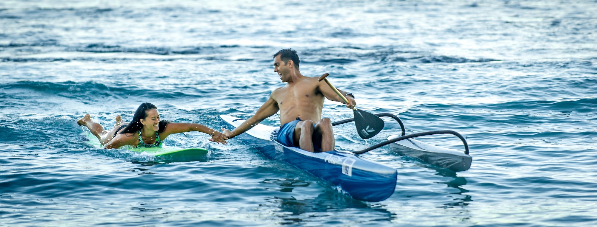 Then Tech. Sgt. Alfred Van Gieson, now Master Sgt., right, a reservist with the 48th Aerial Port Squadron, 624th Regional Support Group, Joint Base Pearl Harbor-Hickam, and his wife Jenny Van Gieson, come back to shore at Waikiki Beach after a morning session of surfing and paddling in Oahu, Hawaii, Aug 13, 2016. Van Gieson is a veteran of Operation Iraqi Freedom, a world champion outrigger, or Va'a, paddler and the coach at the Leeward Kai Canoe Club, which was founded by his grandparents. His wife is a champion surfer and stand-up paddle-boarder. (U.S. Air Force photo by J.M. Eddins Jr.)
