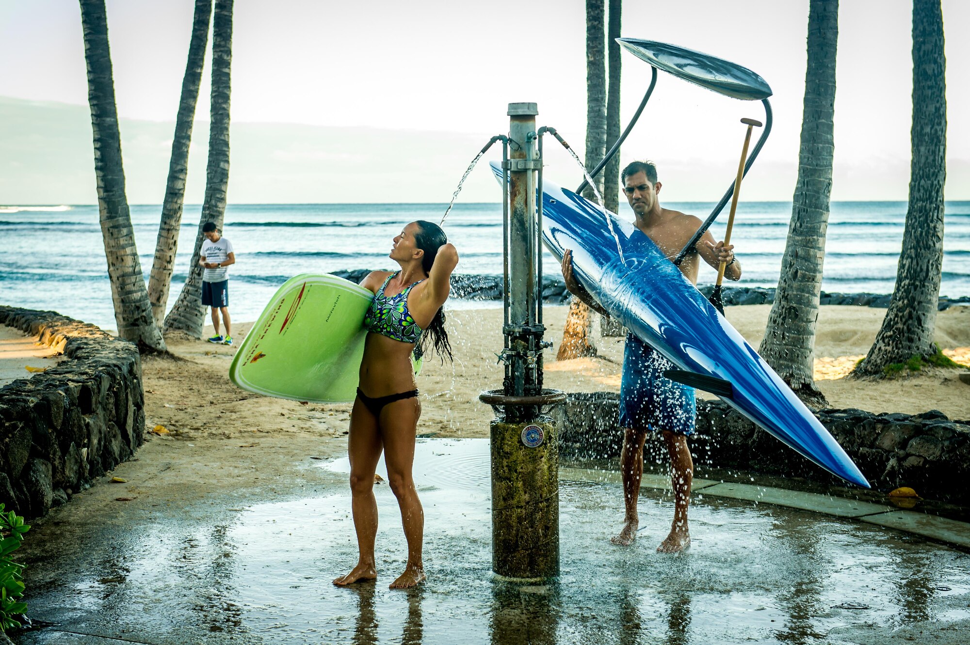 Then Tech. Sgt. Alfred Van Gieson, now Master Sgt., right, a reservist with the 48th Aerial Port Squadron, 624th Regional Support Group, Joint Base Pearl Harbor-Hickam, and his wife Jenny Van Gieson, rinse off their board and canoe at Waikiki Beach after a morning session of surfing and paddling in Oahu, Hawaii, Aug 13, 2016. Van Gieson is a veteran of Operation Iraqi Freedom, a world champion outrigger, or Va'a, paddler and the coach at the Leeward Kai Canoe Club, which was founded by his grandparents. His wife is a champion surfer and stand-up paddle-boarder. (U.S. Air Force photo by J.M. Eddins Jr.)