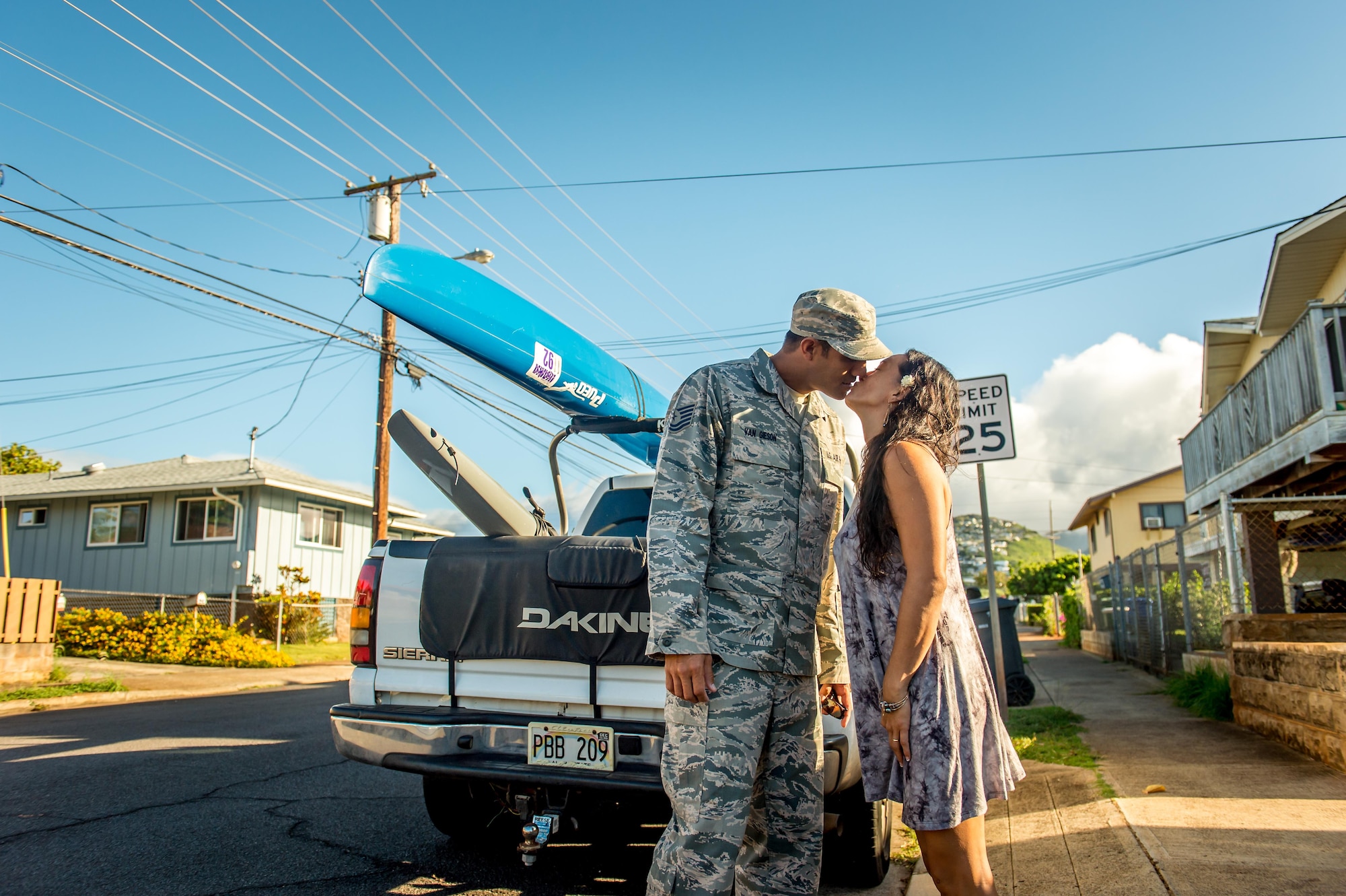 Then Tech. Sgt. Alfred Van Gieson, now Master Sgt., left, a reservist with the 48th Aerial Port Squadron, 624th Regional Support Group, Joint Base Pearl Harbor-Hickam, kisses his wife, Jenny Van Gieson, goodbye before heading to Joint Base Pearl Harbor-Hickam in Oahu, Hawaii, Aug 13, 2016. Van Gieson is a veteran of Operation Iraqi Freedom, a world champion outrigger, or Va'a, paddler and the coach at the Leeward Kai Canoe Club in Nanakuli, Oahu, which was founded by his grandparents. His wife is a champion surfer and stand-up paddle-boarder. (U.S. Air Force photo by J.M. Eddins Jr.)