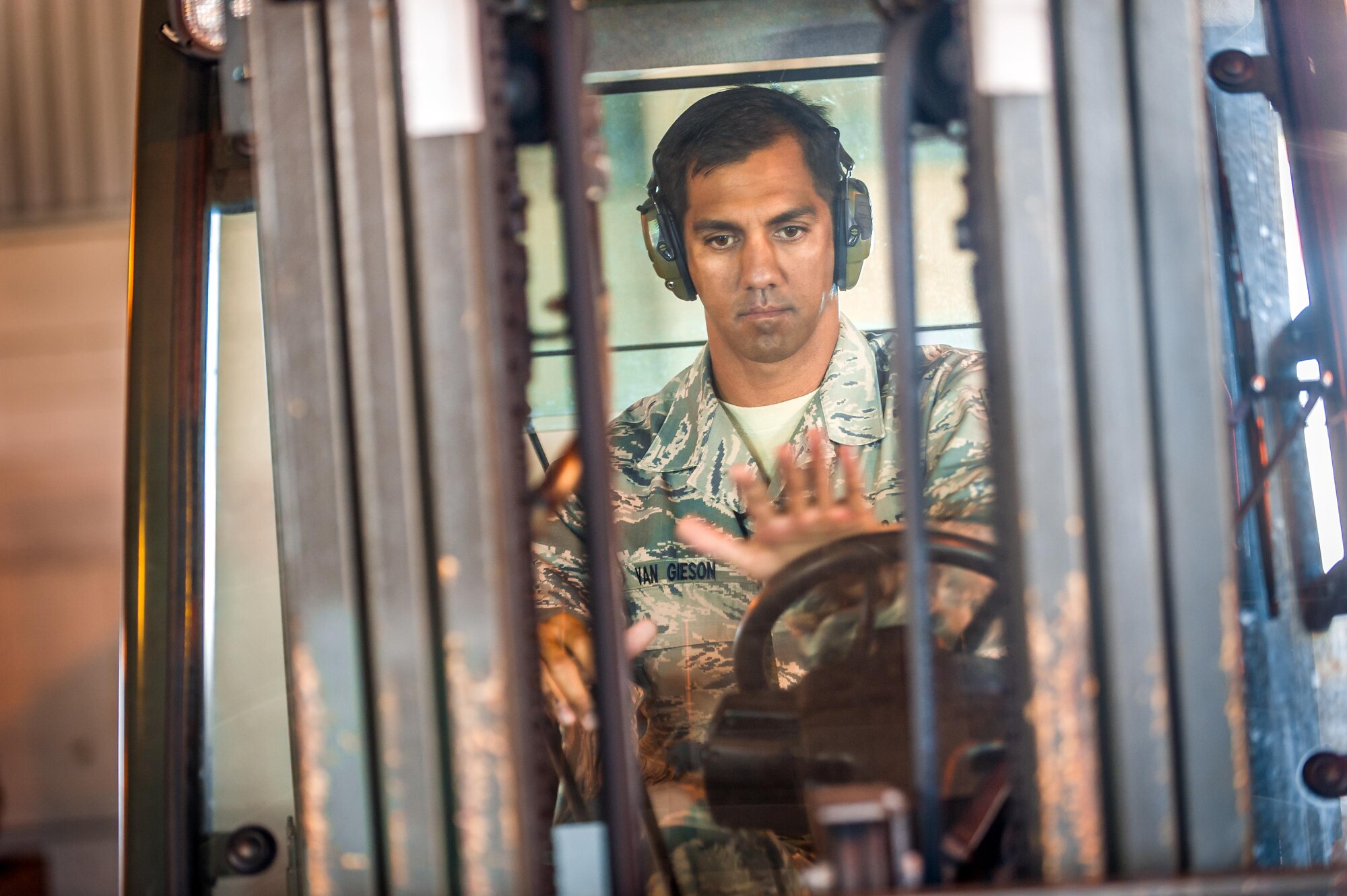 Then Tech. Sgt. Alfred Van Gieson, now Master Sgt., drives a forklift to move cargo at the 48th Aerial Port Squadron, 624th Regional Support Group, Joint Base Pearl Harbor-Hickam, Oahu, Hawaii, Aug 13, 2016. Van Gieson, an Air Force reservist, is a veteran of Operation Iraqi Freedom, a world champion outrigger, or Va'a, paddler and the coach at the Leeward Kai Canoe Club in Nanakuli, Oahu, which was founded by his grandparents. (U.S. Air Force photo by J.M. Eddins Jr.)