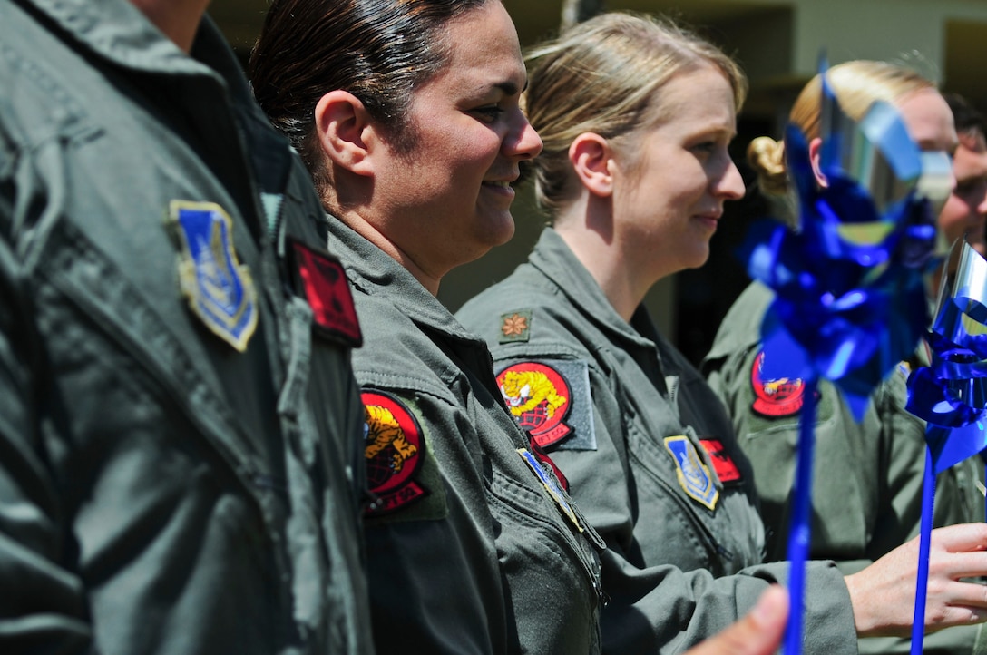 Members of the 535th Airlift Squadron gather together to show their support of National Child Abuse Prevention Month, at Joint Base Pearl Harbor-Hickam, Hawaii, March 29, 2017.  April was designated as National Child Abuse Prevention Month in 1983, acknowledge the importance of families and communities working together to prevent child abuse and neglect, and to promote the social and emotional well-being of children and families. (U.S. Air Force photo by Tech. Sgt. Heather Redman)