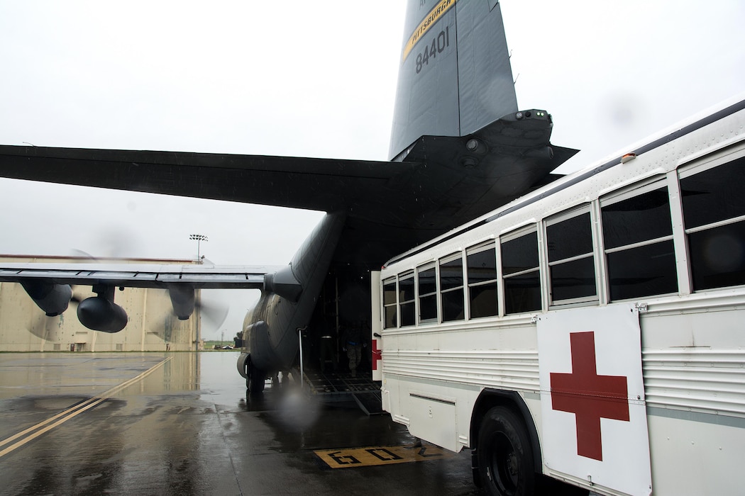 An ambulance bus from the 60th Inpatient Squadron backs up to a C-130 Hercules from Pittsburgh Air Reserve Station, Pennsylvania, during Patriot Delta at Travis Air Force Base, California, March 24, 2017. (U.S. Air Force photo by Staff Sgt. Daniel Phelps)