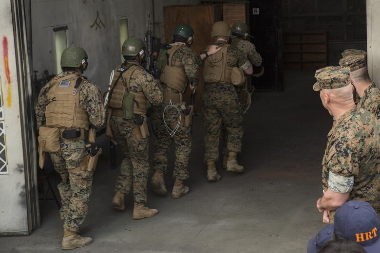 U.S. Marines with the Special Reaction Team (SRT) for Marine Corps Air Station Iwakuni (MCAS), display room-clearing techniques to members of the Hiroshima and Yamaguchi Prefectural Police Headquarters at MCAS Iwakuni, Japan, March 28, 2017. Members with the Hiroshima and Yamaguchi Prefectural Police Headquarters traveled to the air station to observe SRT conduct high-risk training scenarios. The training ranged from room-clearing, breaching, communication and non-lethal take-down techniques. (U.S. Marine Corps photo by Lance Cpl. Joseph Abrego)