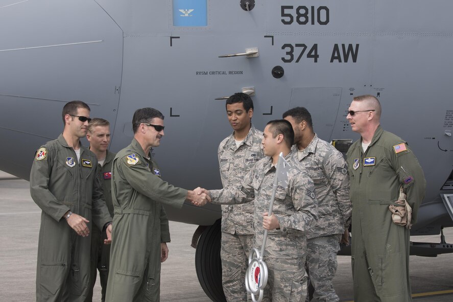 Col. Robert Dotson, 374th Operations Group commander, and Staff Sgt. Raymond Malig, 374th Aircraft Maintenance Squadron crew chief, shake hands in front of a C-130J Super Hercules at Yokota Air Base, Japan, March 29, 2017. Yokota serves as the primary Western Pacific airlift hub for U.S. Air Force peacetime and contingency operations. Missions included tactical air land, airdrop, aeromedical evacuation, special operations and distinguished visitor airlift. (U.S. Air Force photo by Yasuo Osakabe) 