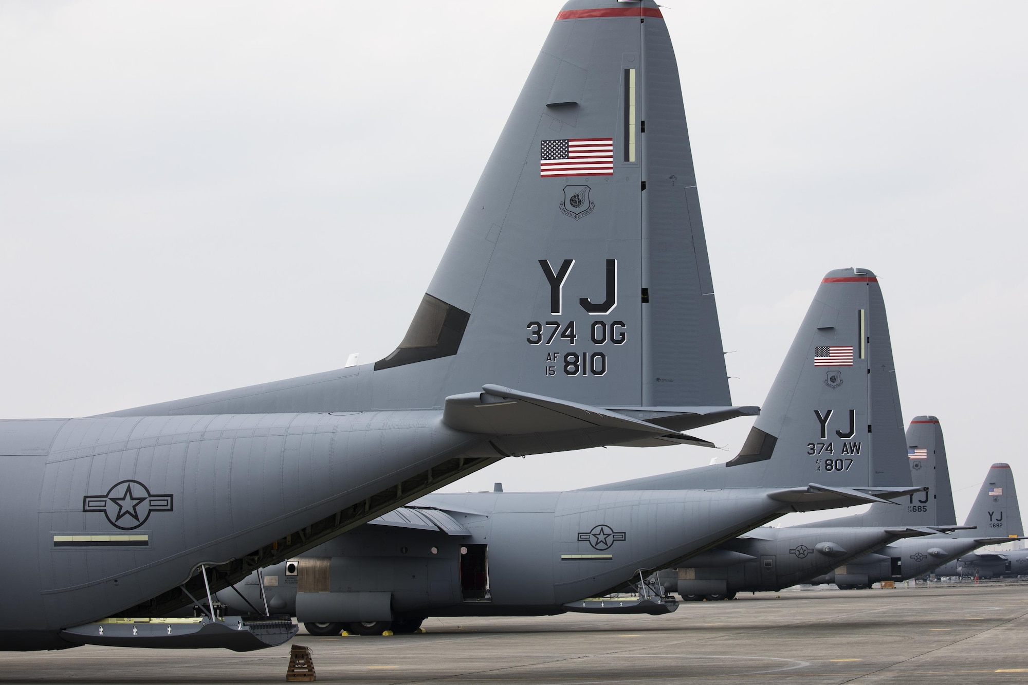 Two C-130J Super Hercules and two C-130H Hercules aircraft sit on the flightline at Yokota Air Base, Japan, March 29, 2017. Yokota is the only forward-based tactical airlift squadron in the Pacific region. They provide C-130 aircrews to conduct theater airlift, special operations, aeromedical evacuation, repatriation and humanitarian relief missions. (U.S. Air Force photo by Yasuo Osakabe)