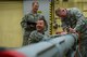 U.S. Air Force Chief Master Sgt. Edwin Ludwigsen 52nd Fighter Wing command chief and Col. Joseph McFall, 52nd FW commander, secure attachments to an Air Intercept Missile 9 at Spangdahlem Air Base, Germany, March 27, 2017. Airmen from the 52nd Maintenance Squadron munitions section work around the clock to support day-to-day flying.(U.S. Air Force photo by Senior Airman Dawn M. Weber)