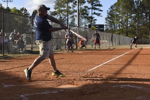 Kristopher K. Berg, Chiefs first baseman, hits the ball at the Chiefs vs. Eagles softball game at the Joint Base Charleston softball fields March 24, 2017. The game helps build comradery between prominent Joint Base Charleston senior enlisted and field grade officers. Team Chiefs, comprised of chief master sergeants, outscored team Eagles, comprised of field grade officers, 27-13.
