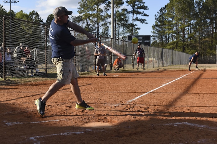 Kristopher K. Berg, Chiefs first baseman, hits the ball at the Chiefs vs. Eagles softball game at the Joint Base Charleston softball fields March 24, 2017. The game helps build comradery between prominent Joint Base Charleston senior enlisted and field grade officers. Team Chiefs, comprised of chief master sergeants, outscored team Eagles, comprised of field grade officers, 27-13.