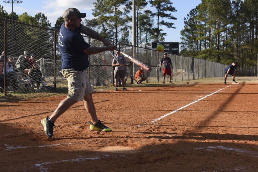 Kristopher K. Berg, Chiefs first baseman, hits the ball at the Chiefs vs. Eagles softball game at the Joint Base Charleston softball fields March 24, 2017. The game helps build comradery between prominent Joint Base Charleston senior enlisted and field grade officers. Team Chiefs, comprised of chief master sergeants, outscored team Eagles, comprised of field grade officers, 27-13.
