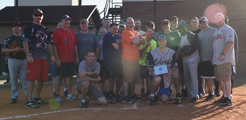 Chiefs and Eagles line up for a postgame group photo at the Joint Base Charleston softball fields March 24, 2017. The game helps build comradery between prominent Joint Base Charleston senior enlisted and field grade officers. Team Chiefs, comprised of chief master sergeants, outscored team Eagles, comprised of field grade officers, 27-13.