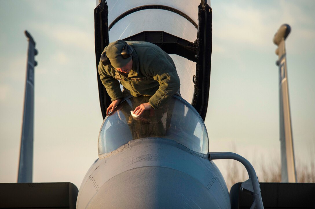 Air Force Staff Sgt. Joshua Matrine cleans the canopy on an F-15C Eagle aircraft at Leeuwarden Air Base in the Netherlands, March 28, 2017. Matrine is a crew chief assigned to the 159th Aircraft Maintenance Squadron. Air Force photo by Staff Sgt. Jonathan Snyder