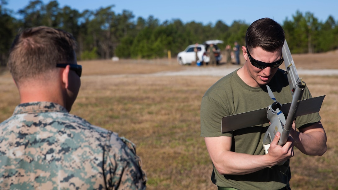 Sgt. Dillon Emery, left, and Sgt. Kyle Phillips, right, prepare a Raven small unmanned aircraft system for flight at Marine Corps Base Camp Lejeune, N.C., March 27, 2017. Marines conducted aerial training exercises at Tactical Landing Zone Dove to demonstrate the capabilities and build familiarization with the SUAS. Emery and Phillips are intelligence specialists with 2nd Battalion, 8th Marine Regiment. 