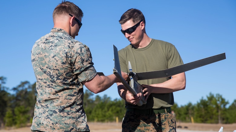 Sgt. Dillon Emery, left, and Sgt. Kyle Phillips, right, construct a Raven small unmanned aircraft system at Marine Corps Base Camp Lejeune, N.C., March 27, 2017. Marines conducted aerial training exercises at Tactical Landing Zone Dove to demonstrate the capabilities and build familiarization with the SUAS. Emery and Phillips are intelligence specialists with 2nd Battalion, 8th Marine Regiment. 