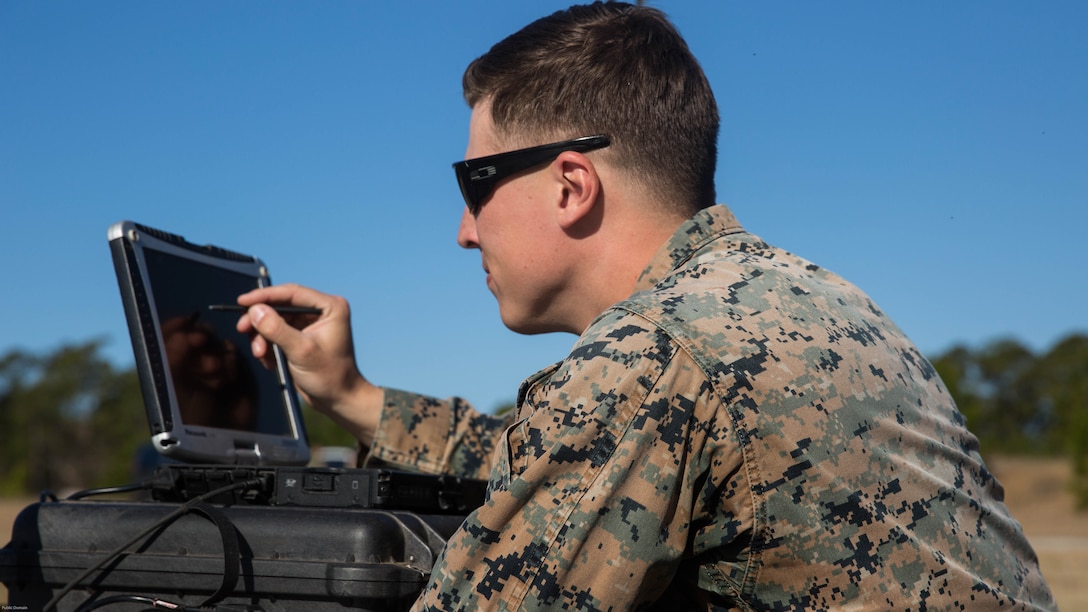 Sgt. Kyle Phillips configures computer equipment to ensure communications and controls connected to a Raven small unmanned aircraft system are working properly at Marine Corps Base Camp Lejeune, N.C., March 27, 2017. Marines conducted aerial training exercises at Tactical Landing Zone Dove to demonstrate the capabilities and build familiarization with the SUAS. Phillips is an intelligence specialist with 2nd Battalion, 8th Marine Regiment. 