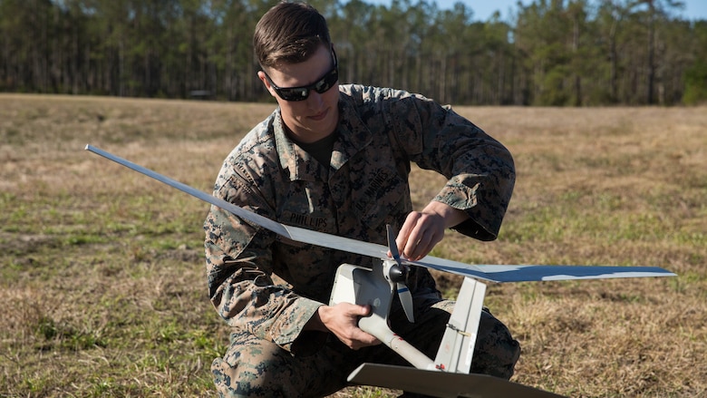 Sgt. Kyle Phillips conducts final checks on a Raven small unmanned aircraft system at Marine Corps Base Camp Lejeune, N.C. on Mar. 27, 2017 to make sure the system will respond properly to controls. Marines conducted aerial training exercises at Tactical Landing Zone Dove to demonstrate the capabilities and build familiarization with the SUAS. Phillips is an intelligence specialist with 2nd Battalion, 8th Marine Regiment. 