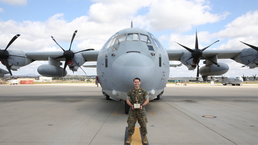 Capt. Christopher Lavergne, a KC-130J Super Hercules pilot with Marine Aerial Refueler Transport Squadron (VMGR) 352, proudly displays the 2017 Marine Corps Aviation Association Henry Wildfang award in front of a KC-130J at Marine Corps Air Station Miramar, Calif., March 27. VMGR-352 received the Henry Wildfang award for successful mission accomplishments and the most mishap free hours. 