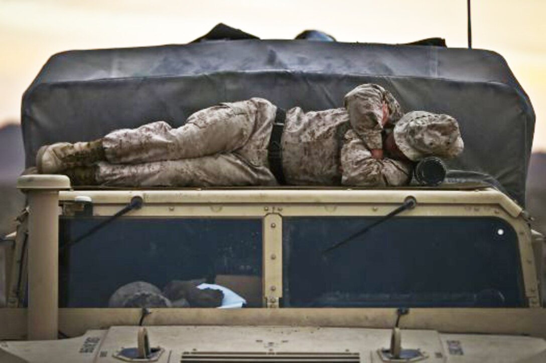 A Marine sleeps on the roof of a vehicle during a training exercise at Marine Corps Air Ground Combat Center, Twentynine Palms, Calif., Feb. 16, 2017. Marine Corps photo by Cpl. Aaron S. Patterson