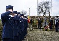 Airmen from 86th Civil Engineer Squadron and 86th Logistics Readiness Squadron salute during a ceremony to commemorate the Wereth 11 in Wereth, Belgium, March 24, 2017. A permanent memorial stands in the exact location in the small village of Wereth where 11 African American soldiers were found tortured and executed by the Nazi SS. The 11 Soldiers were a part of the 333rd Field Artillery Battalion when they were separated during the Battle of the Bulge, and later captured by the Nazi SS. (U.S. Air Force photo by Tech Sgt. Sara Keller)