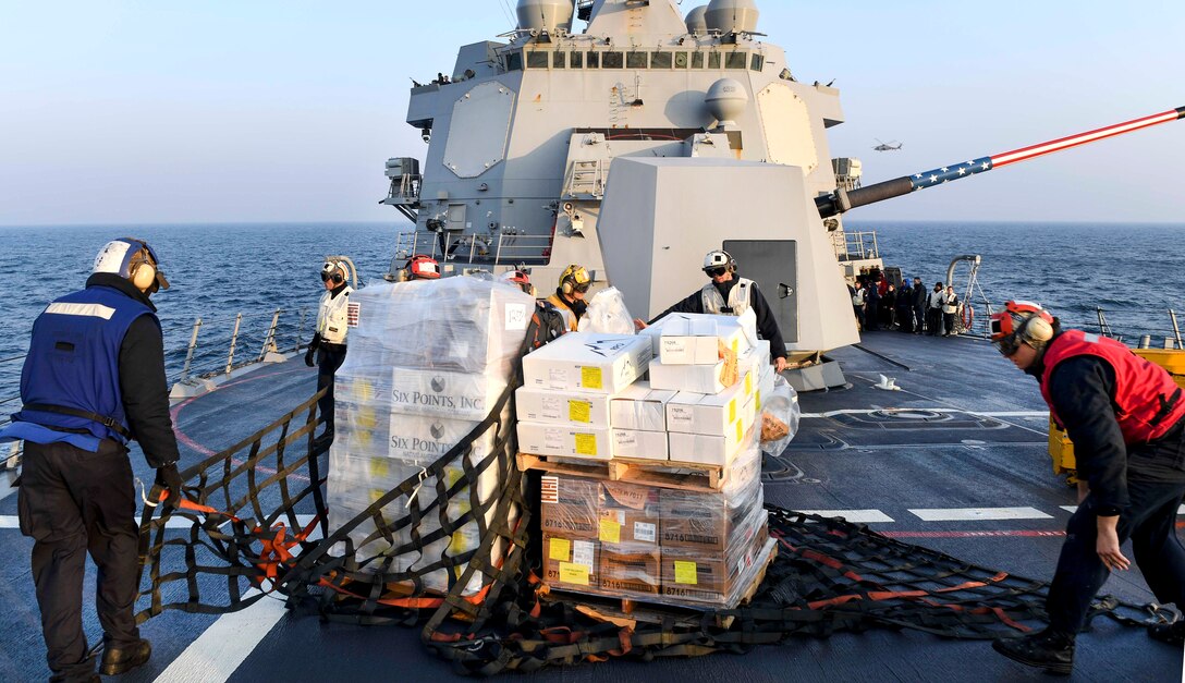 Sailors prepare to transfer cargo received from Lewis and Clark-class dry cargo ship USNS Charles Drew from the forecastle of the Arleigh Burke-class guided-missile destroyer USS Wayne E. Meyer during a vertical replenishment-at-sea in the Pacific Ocean, March 27, 2017. Navy photo by Petty Officer 3rd Class Kelsey L. Adams 