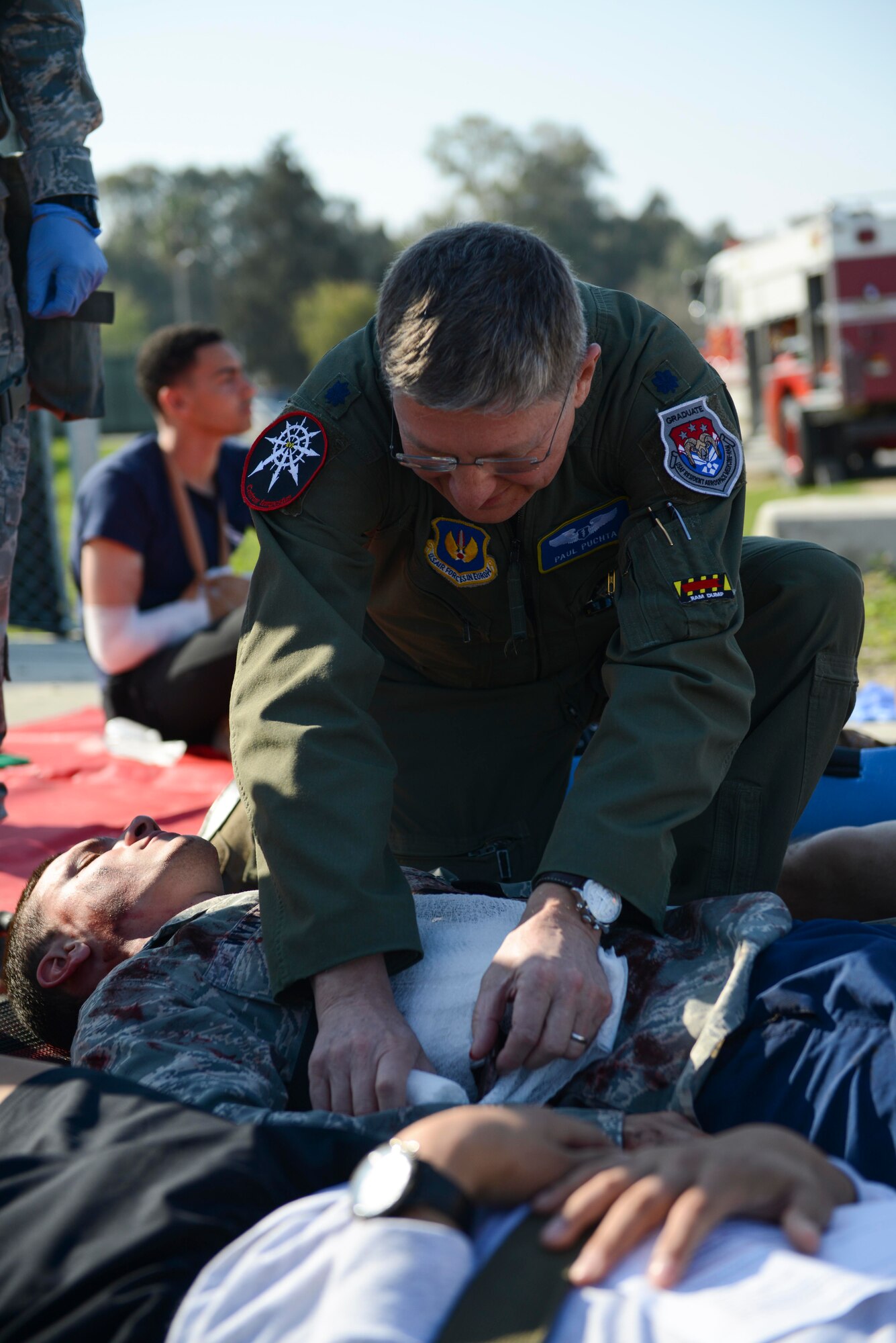 U.S. Air Force Lt. Col. Paul Puchta, 39th Medical Group chief of aerospace medicine, aids a simulated aircraft accident victim during a major accident response exercise (MARE) March 29, 2017, at Incirlik Air Base, Turkey. During a MARE, all simulated medical injuries and victims are treated as if they are real by firefighters and medical personnel.  (U.S. Air Force photo by Airman 1st Class Devin M. Rumbaugh)