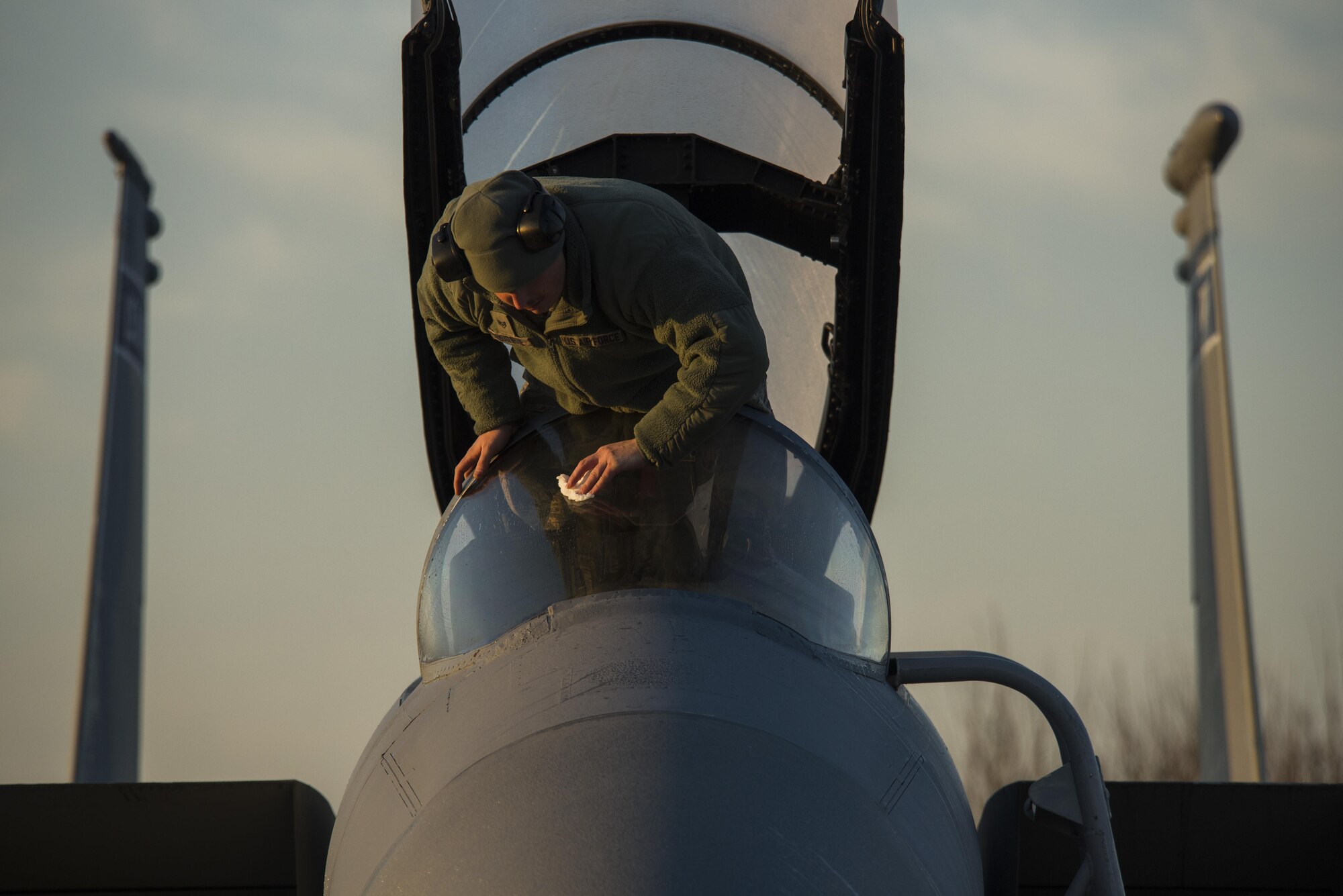 Staff Sgt. Joshua Matrine, 159th Aircraft Maintenance Squadron crew chief, cleans the canopy on a F-15C Eagle from the Louisiana Air National Guard at Leeuwarden Air Base, Netherlands, March 28, 2017. The 122nd Expeditionary Fighter Squadron, comprised of Louisiana and Florida Air National Guard members, will conduct training alongside NATO allies to strengthen interoperability and demonstrate U.S. commitment to the security and stability of Europe. (U.S. Air Force photo by Staff Sgt. Jonathan Snyder)
