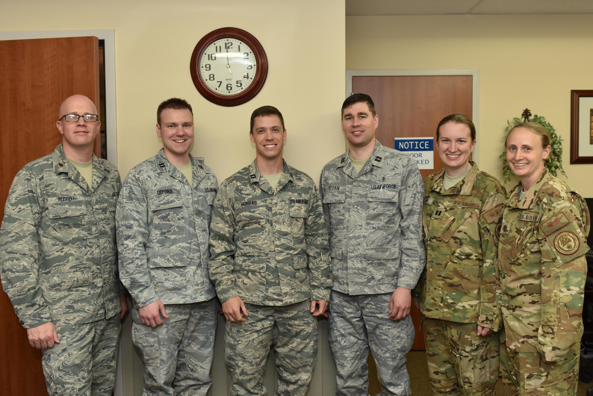(left to right) Maj. Travis Russell, 341st Medical Group chief of medical staff; Capt. Colin Deford and Capt. Stephen Horras, both 341st Medical Operations Squadron family practice physicians; Capt. Travis Sloan, 341st MDOS Squadron pediatrician; Capt. Melissa Cook, 341st MDOS, flight medicine provider and Maj. Melonie Parmley, 341st MDG chief of aerospace medicine pose for a photo March 28 in support of National Doctors Day at Malmstrom Air Force Base, Mont. National Doctors Day is observed annually on March 30 and recognizes the accomplishments of doctors around the nation as well as their contributions to society. (U.S. Air Force photo/Jason Heavner)  