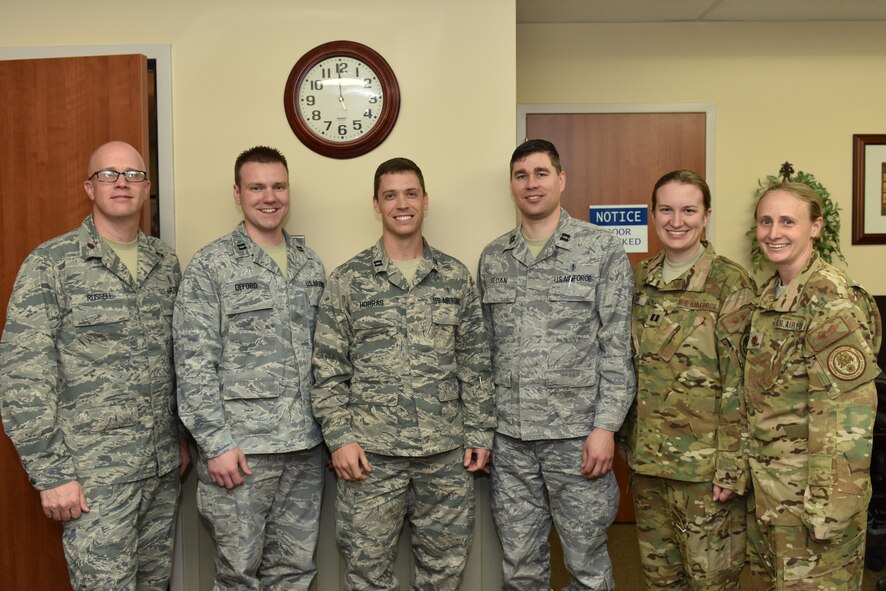 (left to right) Maj. Travis Russell, 341st Medical Group chief of medical staff; Capt. Colin Deford and Capt. Stephen Horras, both 341st Medical Operations Squadron family practice physicians; Capt. Travis Sloan, 341st MDOS Squadron pediatrician; Capt. Melissa Cook, 341st MDOS, flight medicine provider and Maj. Melonie Parmley, 341st MDG chief of aerospace medicine pose for a photo March 28 in support of National Doctors Day at Malmstrom Air Force Base, Mont. National Doctors Day is observed annually on March 30 and recognizes the accomplishments of doctors around the nation as well as their contributions to society. (U.S. Air Force photo/Jason Heavner)  