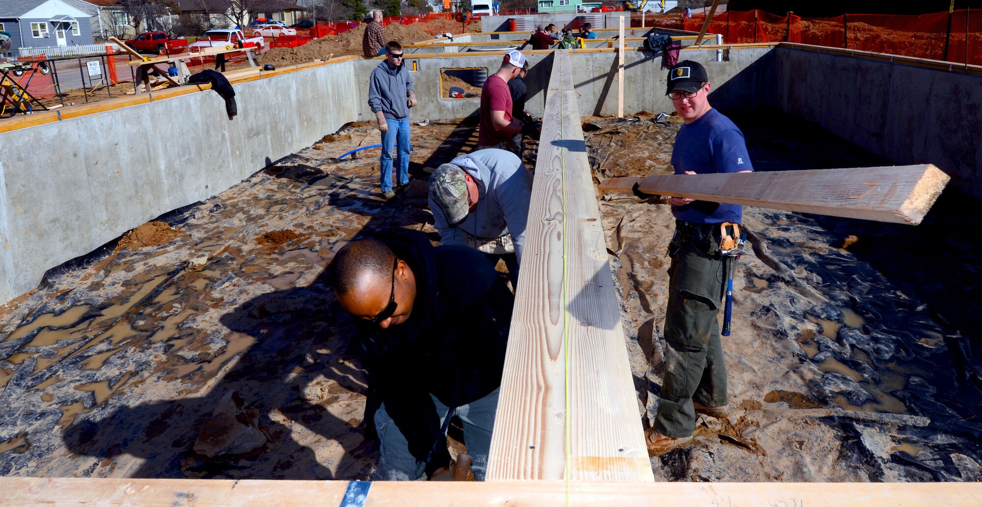 Members of the 28th Civil Engineer Squadron finish installing low-barring walls in a Habitat for Humanity home in Rapid City, S.D., March 23, 2017. During the build, members of the 28th CES were able to participate as a team and enhance their construction skills for use while deployed. (U.S. Air Force photo by Airman 1st Class Donald C. Knechtel)