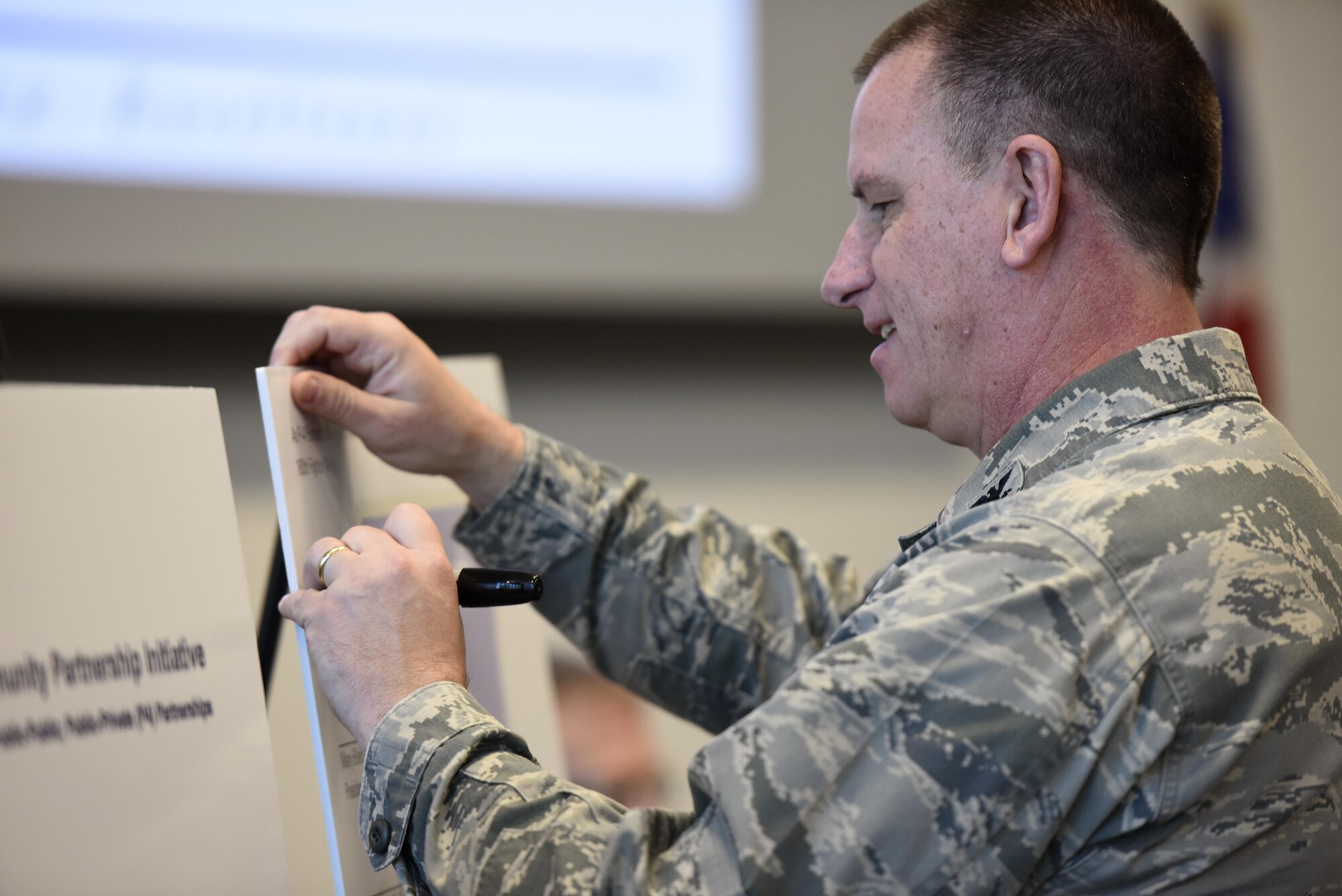 U.S. Air Force Col. Scott Reed, vice wing commander of the 180th Fighter Wing, Ohio Air National Guard, signs the Higher Degree Attainment Initiative March 22, 2017 at the 180FW in Swanton, Ohio. The agreement between the 180FW and five local-area universities provides additional education opportunities for 180FW Airmen while providing participating colleges with recruitment opportunities.  (U.S. Air National Guard photo by Staff Sgt. Shane Hughes)