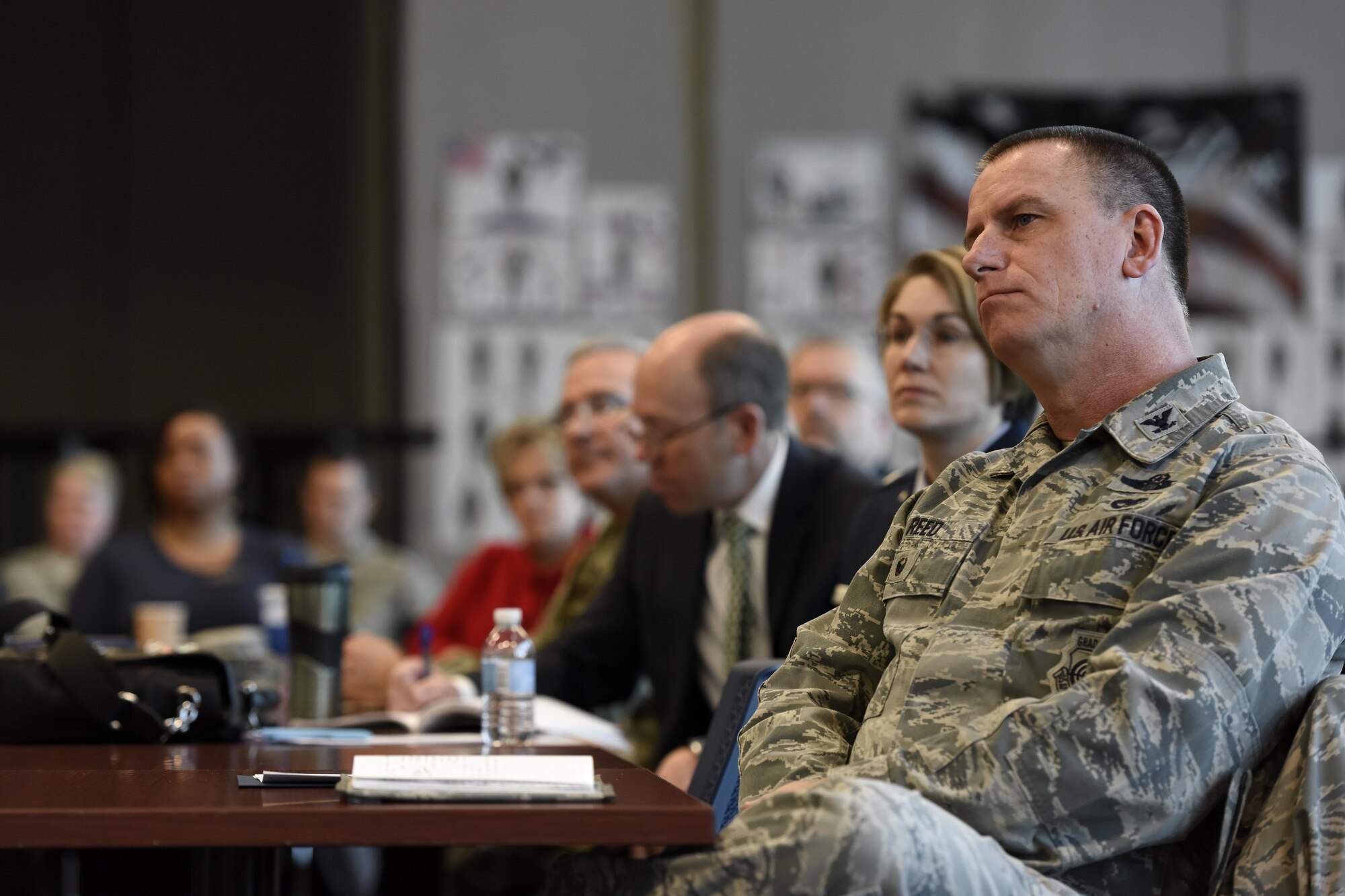 U.S. Air Force Col. Scott Reed, vice wing commander of the 180th Fighter Wing, Ohio Air National Guard, listens to a guest speaker during an Air Force Community Partnership agreement signing March 22, 2017, at the 180FW in Swanton, Ohio. The AFCP program has inspired 61 installations nationwide to partner with their local communities across a wide range of initiatives, tapping into the intellectual capital and innovative spirit of Airmen and community leaders across the nation to develop creative ways to accomplish the U.S. Air Force mission and strengthen local communities. (U.S. Air National Guard photo by Staff Sgt. Shane Hughes)