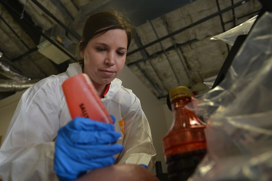 U.S. Air Force Special Agent Shelly Herold, Air Force Office of Special Investigations 2nd Field Investigative Squadron forensic science consultant assigned to Joint Base Andrews, Maryland, squeezes fake blood into a simulated replica at Shaw Air Force Base, S.C., March 28, 2017. The forehead was used in a forensic science demonstration as a target, allowing onlookers to have a realistic experience of bloodstain pattern analysis. (U.S. Air Force photo by Airman 1st Class Destinee Sweeney)