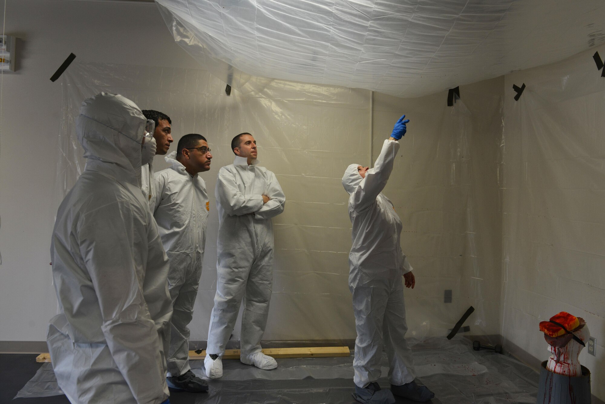 U.S. Air Force Special Agent Shelly Herold, Air Force Office of Special Investigations (AFOSI) 2nd Field Investigative Squadron forensic science consultant assigned to Joint Base Andrews, Maryland, right, explains blood patterns at Shaw Air Force Base, S.C., March 28, 2017. Forensic science consultants help process crime scenes and provide training to AFOSI detachments. (U.S. Air Force photo by Airman 1st Class Destinee Sweeney)