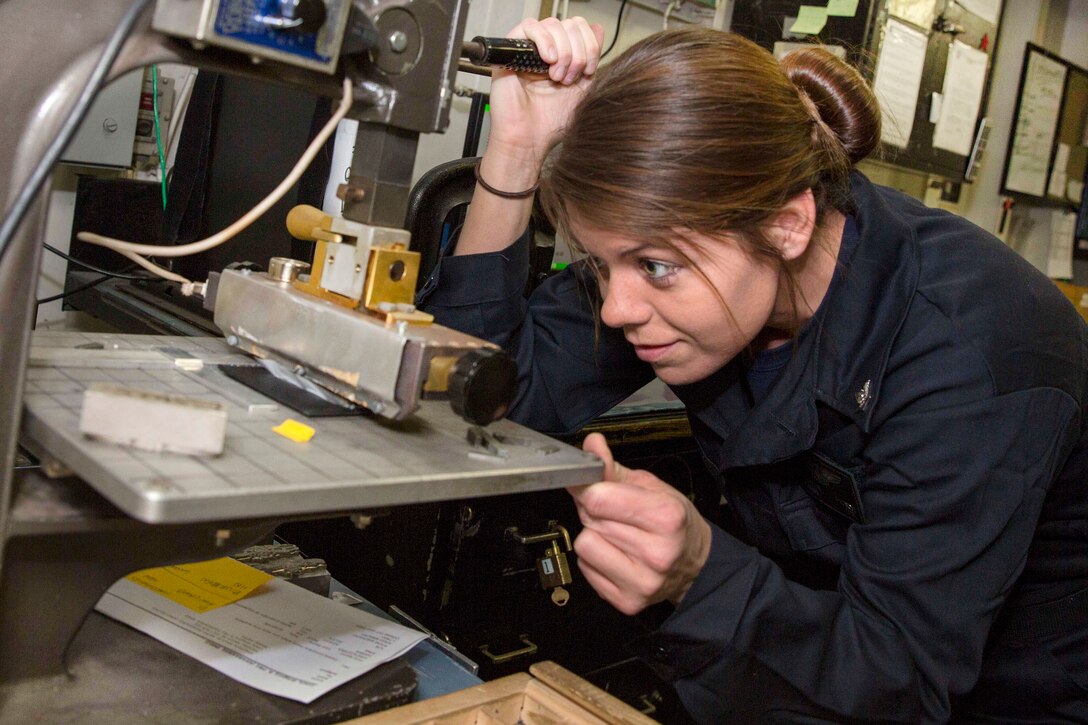 Navy Petty Officer 3rd Class Brooklyn Pitsch makes a name tag in the equipment repair shop aboard the amphibious assault ship USS Kearsarge in the Atlantic Ocean, March 22, 2017. Pitsch is an aircrew survival equipmentman. The ship is underway conducting routine shipboard certifications. Navy photo by Petty Officer 3rd Class Ryre Arciaga