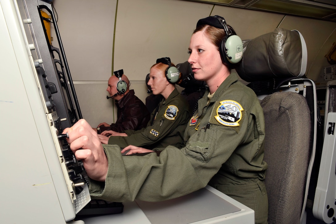 Airman 1st Class Rebecca Green, right, works at her station with other technicians during a training flight near Tinker Air Force Base, Okla., March 24, 2017. Green is an airborne surveillance technician assigned to the 963rd Airborne Air Control Squadron, 552nd Air Control Wing. The mission provided local and regional media an opportunity to learn about the mission of the E-3 Airborne Warning and Control System which celebrated its 40th anniversary at Tinker AFB March 23, 2017. Air Force photo by Greg L. Davis