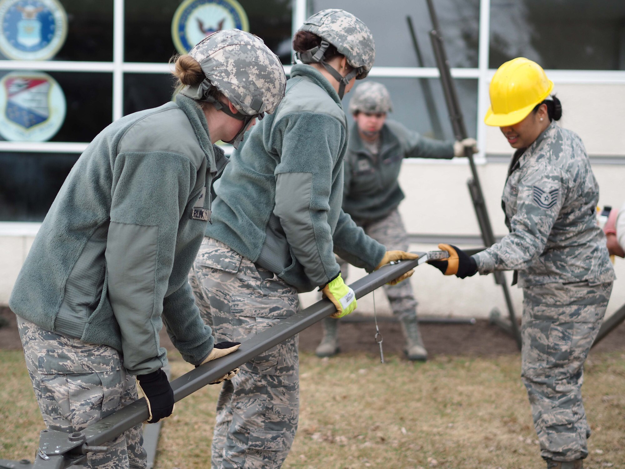 934th Force Support Squadron members assemble the frame for the Single Pallet Expeditionary Kitchen.
