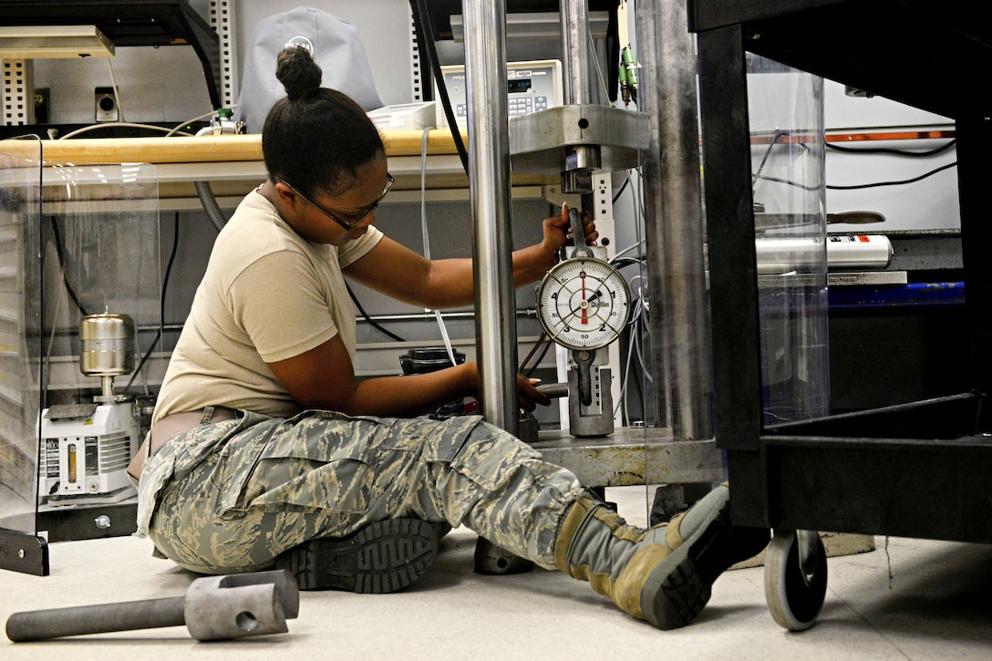 Air Force Airman 1st Class Nakeisha Mitchell resets a force press at Shaw Air Force Base, S.C., March 27, 2017. Mitchell is a precision measurement equipment laboratory technician assigned to the 20th Component Maintenance Squadron, adjusted the force press to calibrate load cells, which are used to weigh aircraft. Air Force photo by Airman 1st Class Destinee Sweeney